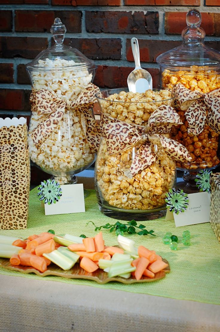 a table topped with lots of candy and candies next to bags of carrots