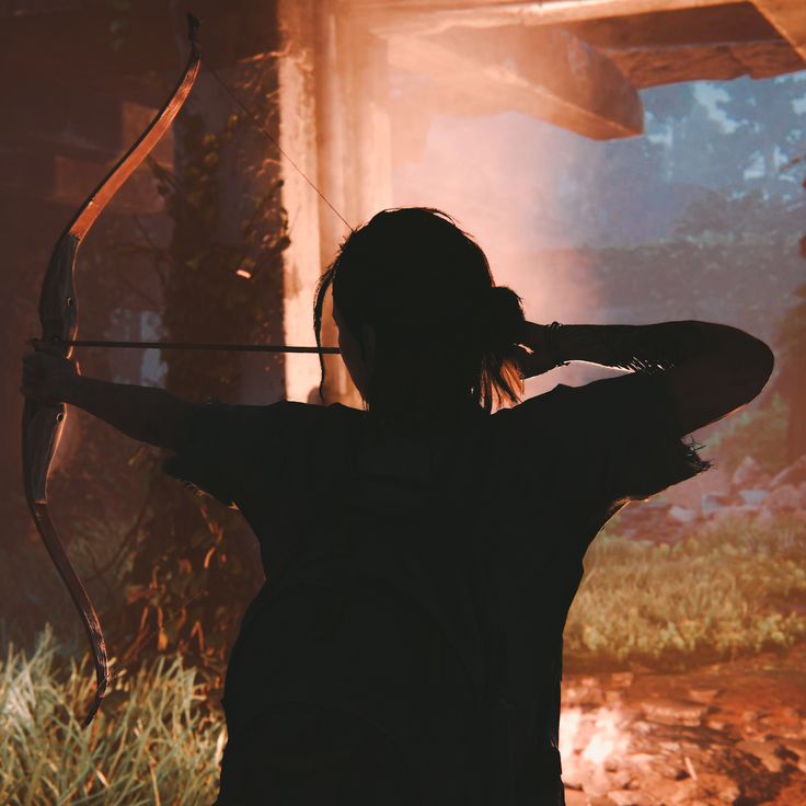 a woman holding a bow and arrow in her hands