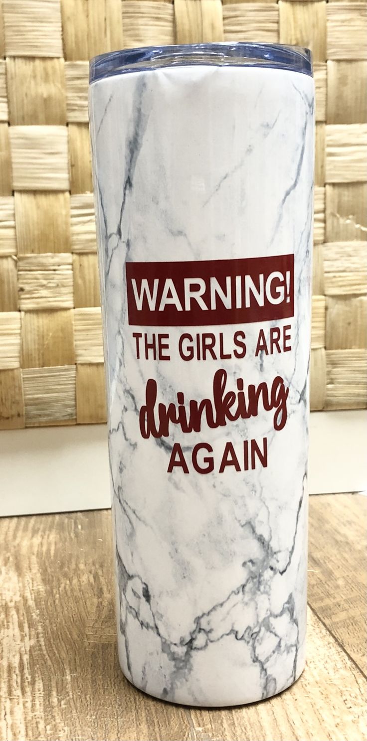 a white marble tumbler with the words warning the girls are drinking again