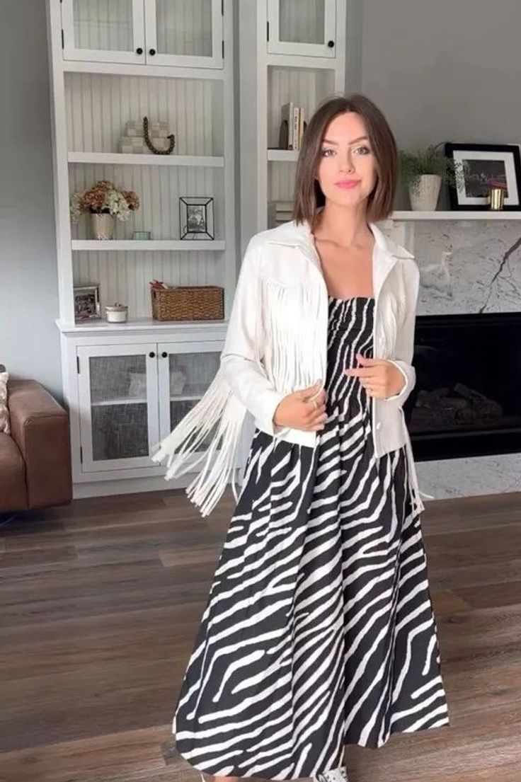 If you're looking to make a statement, why not try styling a zebra print dress? With its bold and daring design, this style can be easily dressed up or dressed down depending on the occasion. Whether you want to incorporate this animal print for a casual day look or a night out, the possibilities are endless. Shop this entire outfit on Honest Darling's LTK! Summer Black Maxi Dress With Zebra Print, Chic Zebra Print Party Dress, Zebra Dress Street Style, Black Zebra Print Maxi Dress, Summer Wardrobe Staples, Zebra Print Dress, Zebra Dress, Fringe Jacket, Chic Zebra Print V-neck Dress