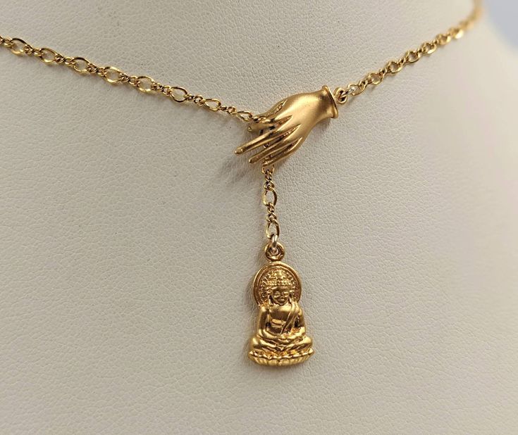 "This meaningful, unique necklace is a 925 Sterling Buddha pendant plated with 24K gold and matching hand of Fatima. Chain is Upgraded 14k gold filled infinity. Item specifics: Length: select (contact us for unlisted lengths) Buddha Charm: approx. 13mm gold Vermeil (925 sterling plated with 24K gold) Hand: approx. 20mm gold Vermeil Chain: approx. 2mm Your Necklace ALSO COMES WITH: 1. A custom BellaIpsa jewelry box -- see pictures throughout the site! 2. A BellaIpsa bookmark with more details abo Buddha Gold, Hand Of Hamsa, Gold Buddha, Necklace Infinity, Drip Drop, Buddha Necklace, Buddha Pendant, Gold Hand, Hand Of Fatima