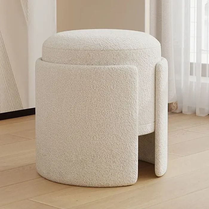 a large white stool sitting on top of a hard wood floor next to a window