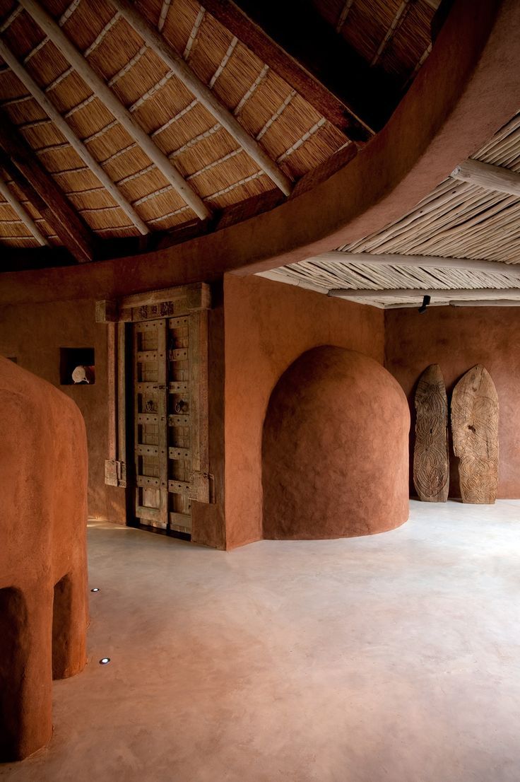 the interior of an adobe - style building with stone arches