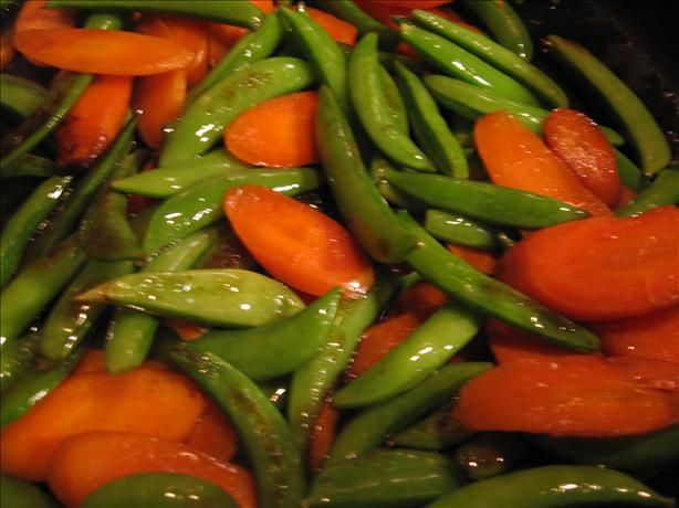 green beans and carrots cooking in a wok