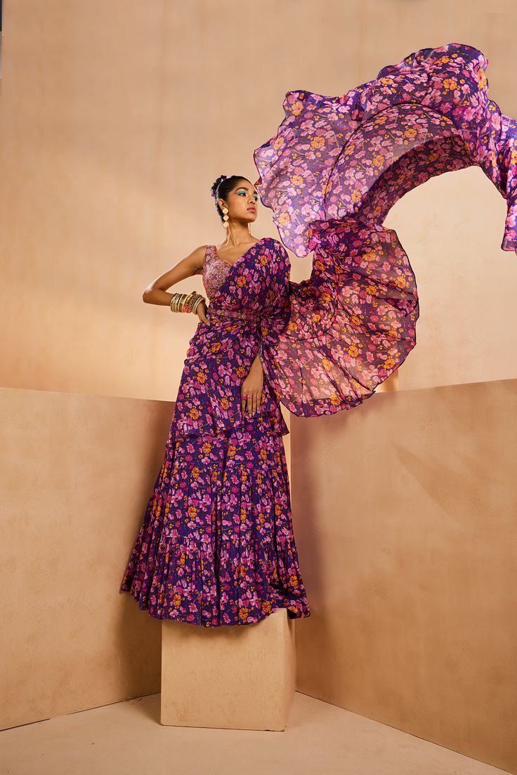 Featuring a floral printed tiered pre-draped sari. It features a very intricately fully hand-embroidered blouse with colorful Japanese bugle beads and sequences. The belt adorned with boho beads accentuates the sari further.From Aneesh Agarwaal's Seher collection.DELIVERY TIMEPlease allow 8-12 weeks for your outfit to arrive.FABRIC DETAILSChinonProfessional cleaning only. Bohemian Designer Choli With Sheer Dupatta, Multicolor Floral Print Pre-draped Georgette Saree, Bohemian Blouse With Sheer Dupatta In Traditional Drape, Bohemian Blouse Piece With Sheer Dupatta, Navratri Silk Pre-draped Saree With Floral Print, Bohemian Multicolor Pre-draped Saree With Sheer Dupatta, Bohemian Blouse Piece With Sheer Dupatta For Festive Occasions, Bohemian Pre-draped Saree With Sheer Dupatta For Designer Wear, Festival Silk Saree With Floral Print