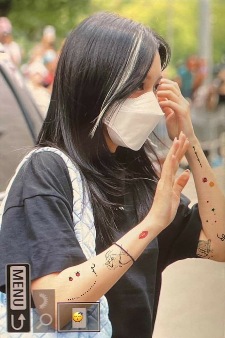 a woman wearing a face mask and holding her hands together