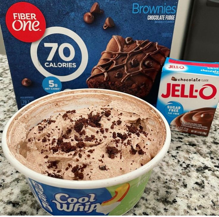 a bowl of ice cream next to a box of jello - o'brownies