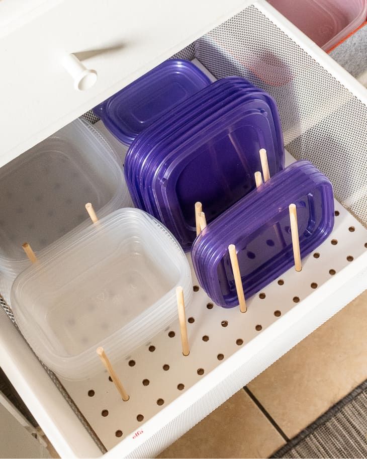 several plastic containers and toothpicks in a drawer