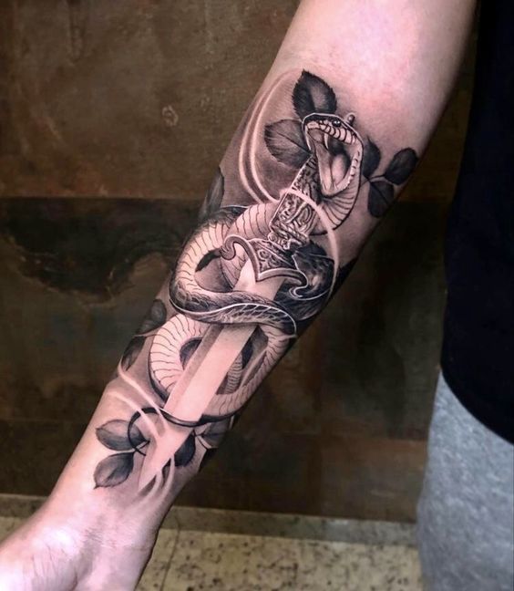 a man's arm with a snake and flower tattoo on the left side of his arm