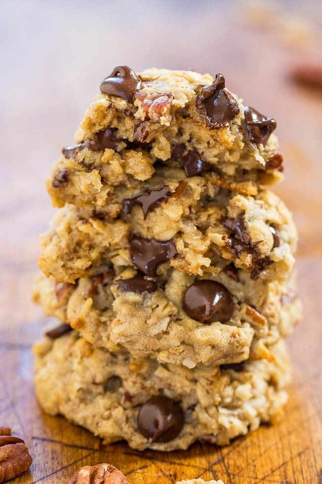 three cookies stacked on top of each other with chocolate chips and pecans around them