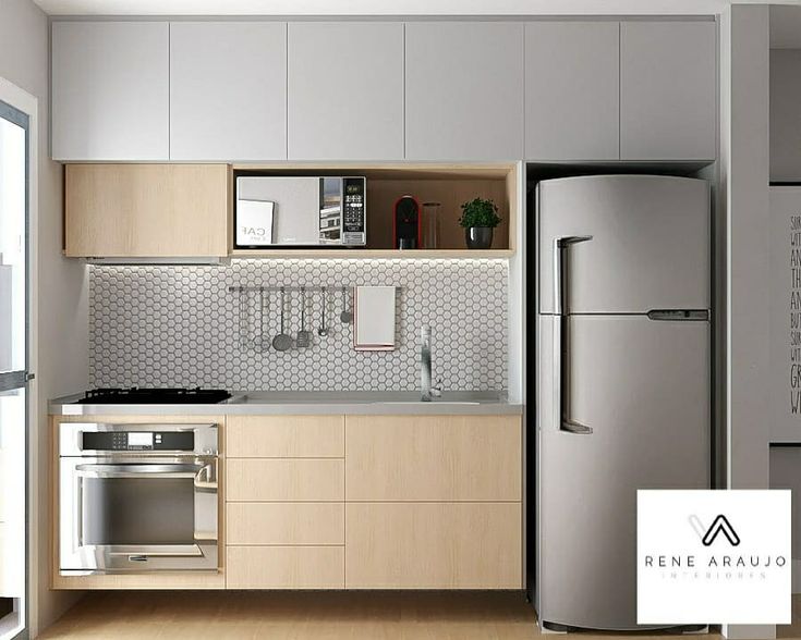 a modern kitchen with stainless steel appliances and wood cabinets