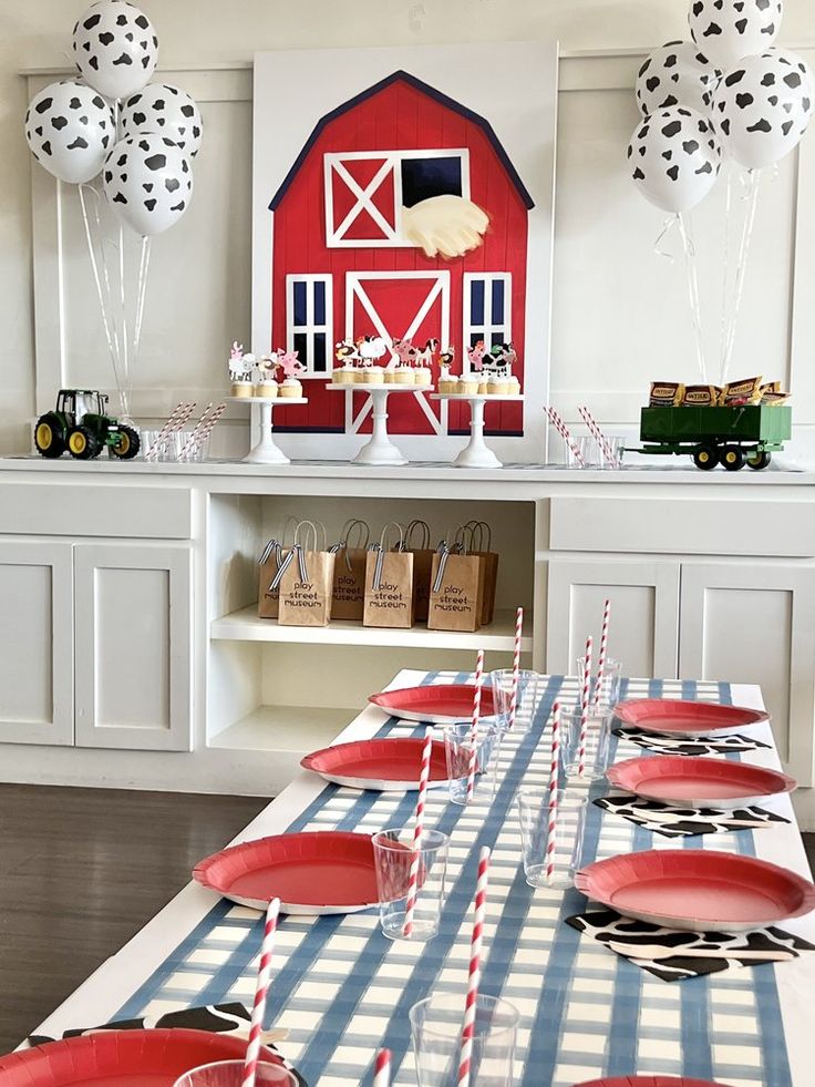 a farm themed birthday party with red, white and blue plates on a table cloth