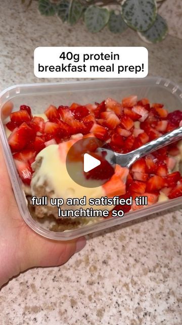 someone is holding a plastic container with strawberries and ice cream in it that says, 40g protein breakfast meal prep