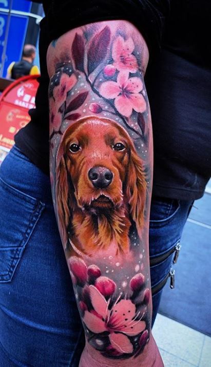 a woman's arm with a dog and flowers on it