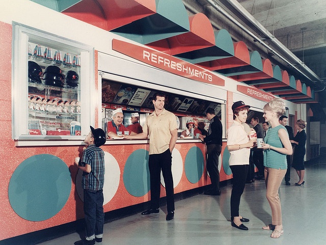 some people are standing in front of a vending machine