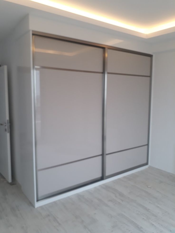 an empty room with white walls and sliding doors