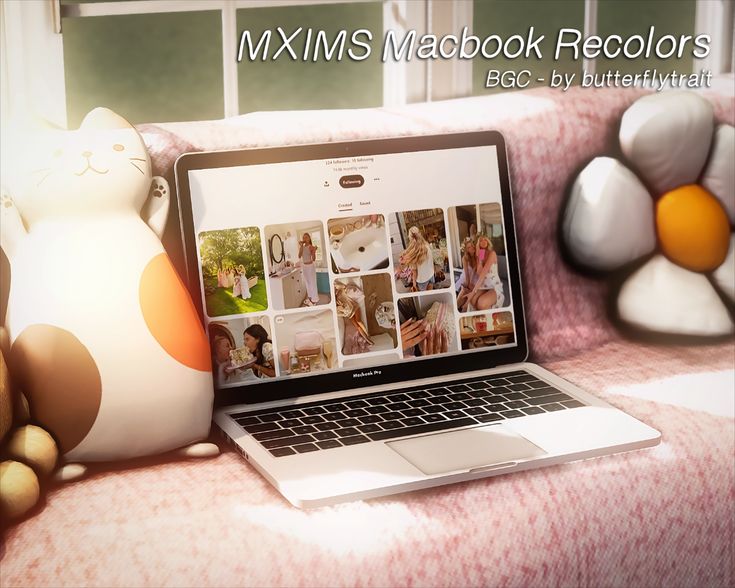 an open laptop computer sitting on top of a couch next to stuffed animals and teddy bears