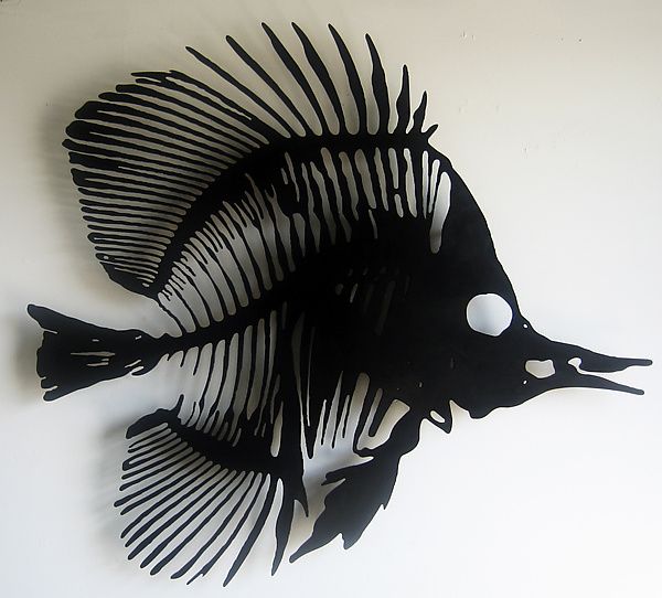 a fish made out of metal on a white wall in the shape of a clock