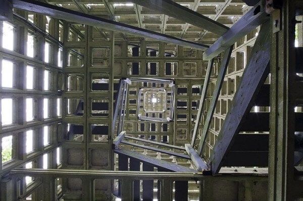 the inside of a metal structure with lots of windows