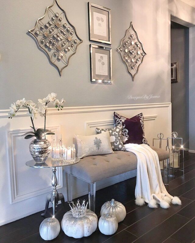 a living room filled with furniture and pictures on the wall