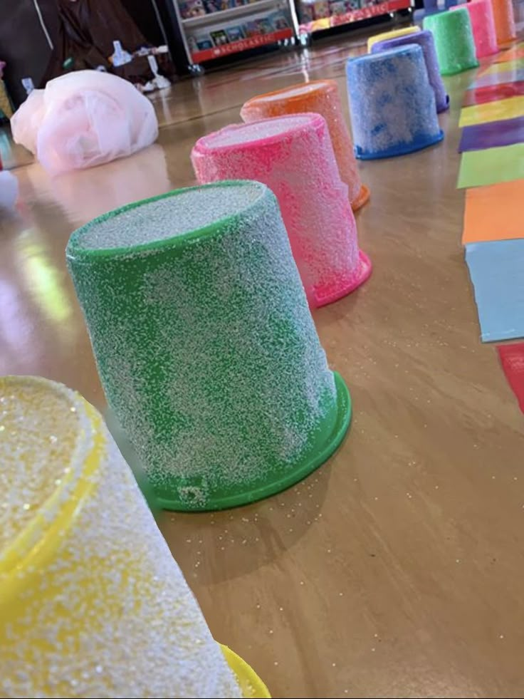 there are many different colored hats on the floor in front of some children's toys