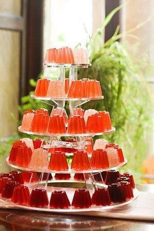 there is a cake made out of jellys on the table in front of a potted plant