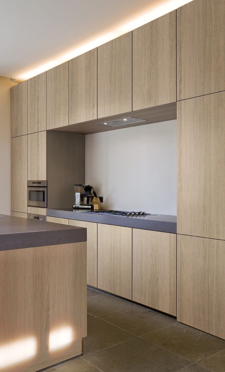 a kitchen with wooden cabinets and black counter tops