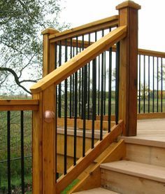 a wooden staircase with metal railing and handrail