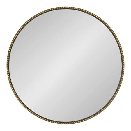 a round mirror with beaded trim around the edges and an oval frame, on a white background