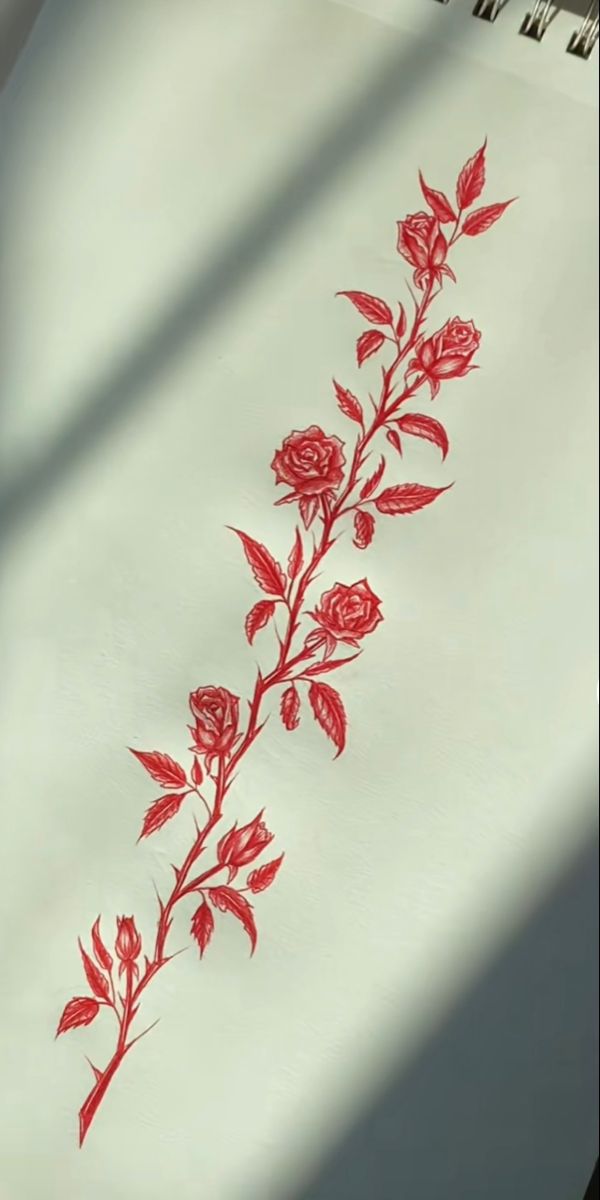 a red rose is drawn on a white sheet