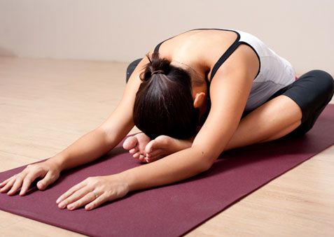 a woman is doing yoga on a mat