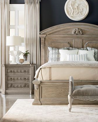 a bedroom with a bed, dresser and mirror