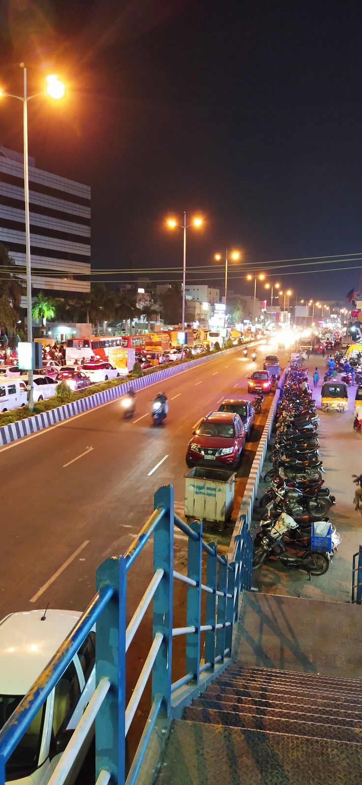 many cars are parked on the street at night