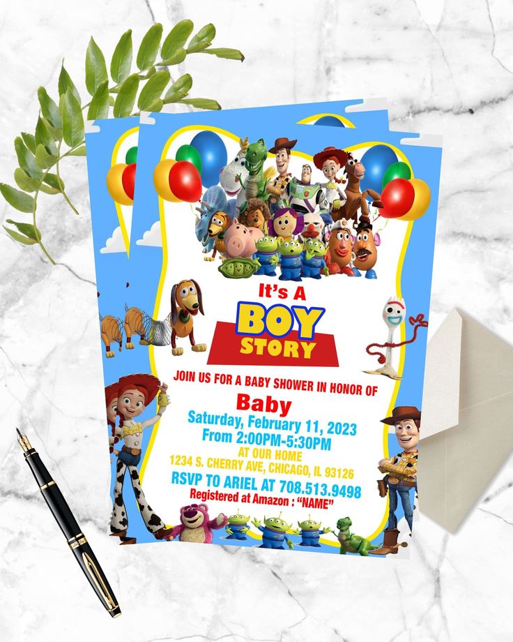 the toy story baby shower party is set up on a marble table with a pen and envelope