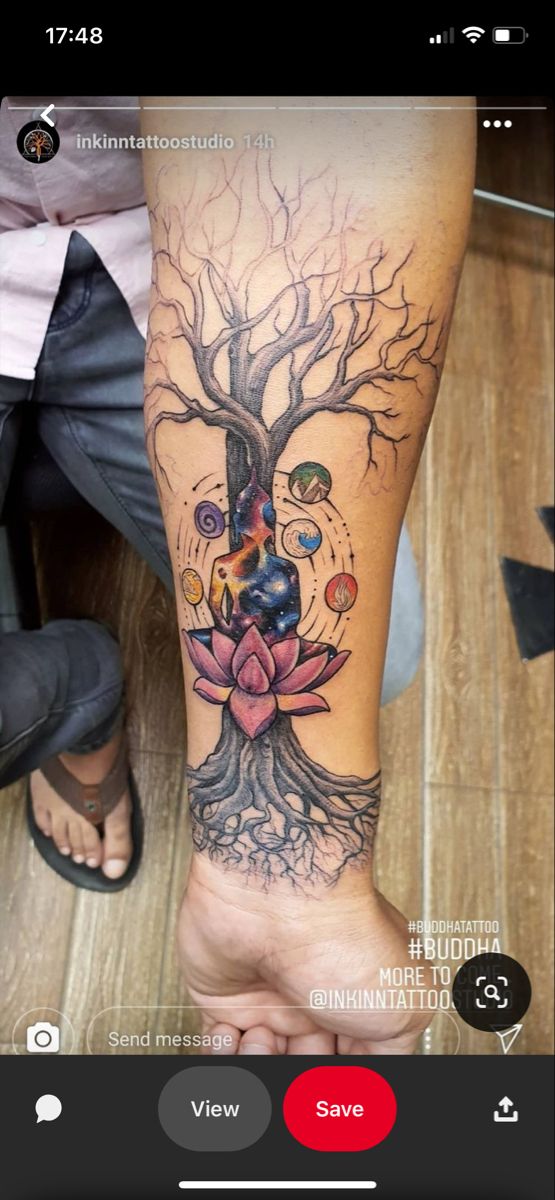 a person with a tree tattoo on their arm