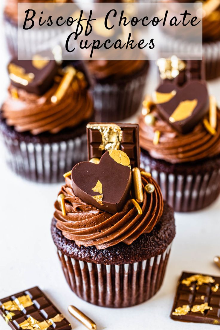 cupcakes with chocolate frosting and gold decorations in the shape of heart on top