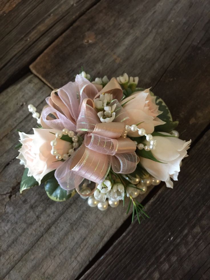 a bridal bouquet sitting on top of a wooden table