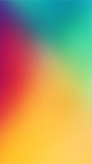 a blurry image of an orange, yellow and blue background with the colors of rainbow