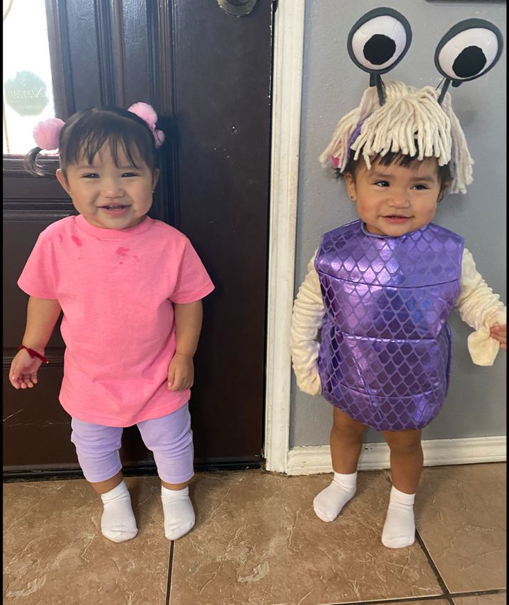 two young children dressed in costumes standing next to each other