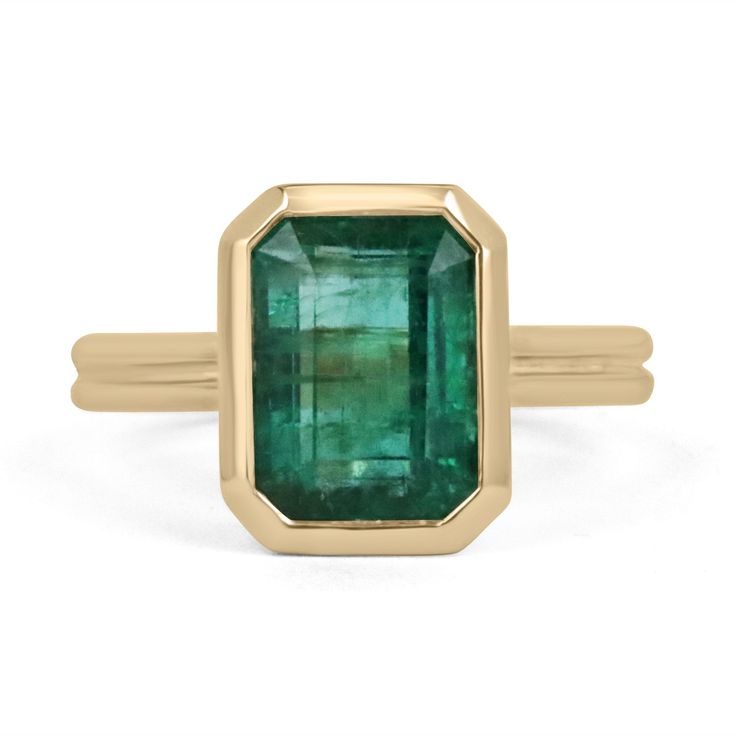 Displayed is a stunning emerald solitaire engagement or right-hand ring in 14K yellow gold. This gorgeous solitaire ring carries an estimated 4.45-carat emerald in a bezel setting. Fully faceted, this gemstone showcases excellent shine and beautiful, dark green color. The emerald has very good clarity with minor flaws that are normal in all genuine emeralds. An ideal solitaire, perfect for everyday use.  Setting Style: Bezel Setting Material: 14K Yellow Gold         Setting Weight: 6.0 Grams Main Stone: Emerald Shape: Emerald Cut Estimated Weight: 4.45-Carats Clarity: Transparent Color: Dark Green Luster: Very Good Treatments: Natural, Oiling Origin: Zambia Estimated Retail Value: $11,450 USD Keep in mind we custom create all of the items listed here. If you have a special request for a cu Gia Certified Timeless Octagon Emerald Ring, Classic Gia Certified Emerald Ring, Gia Certified Baguette Cut Emerald Ring In 14k Gold, Luxury Solitaire Emerald Ring In Yellow Gold, Gia Certified Timeless Emerald Ring For May Birthstone, Formal Octagon Solitaire Emerald Ring, Luxury Yellow Gold Emerald Solitaire Ring, Timeless 14k Gold Baguette Cut Emerald Ring, Timeless Gia Certified Emerald Ring For May Birthstone