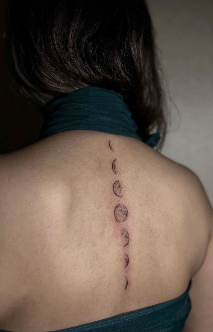 the back of a woman's shoulder with phases on it