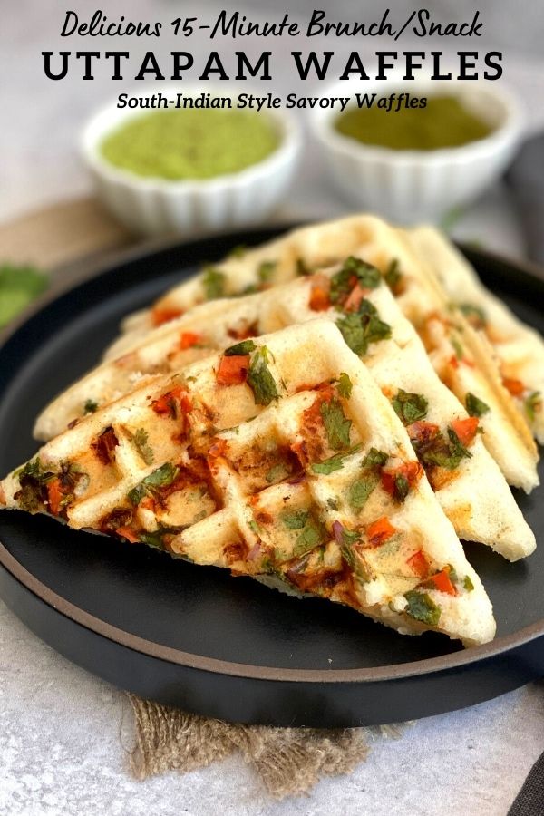 three waffles on a black plate with green dipping sauce in the bowl behind them