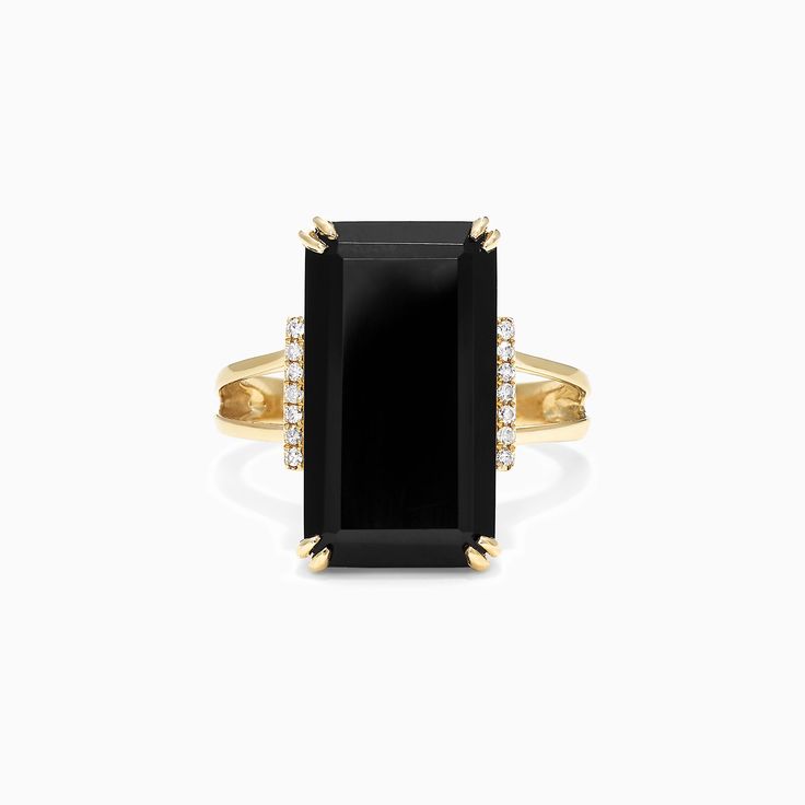 a gold ring with black onyxite and diamonds