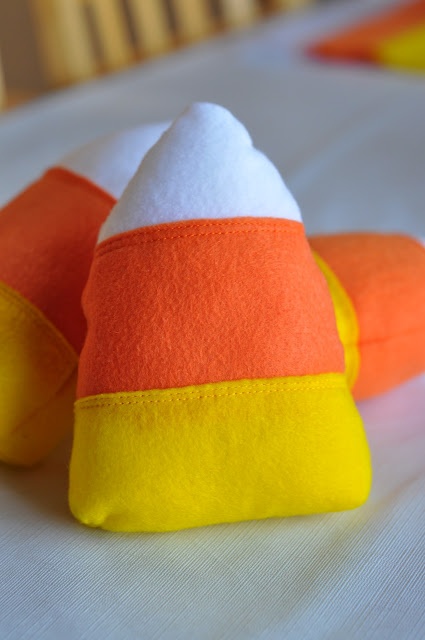 two orange and white slippers sitting on top of a bed