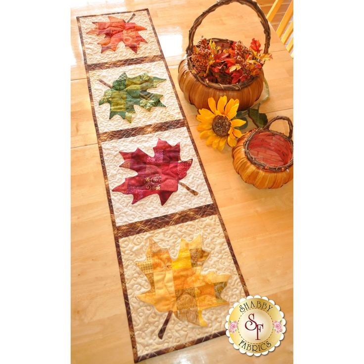 the table runner is decorated with autumn leaves