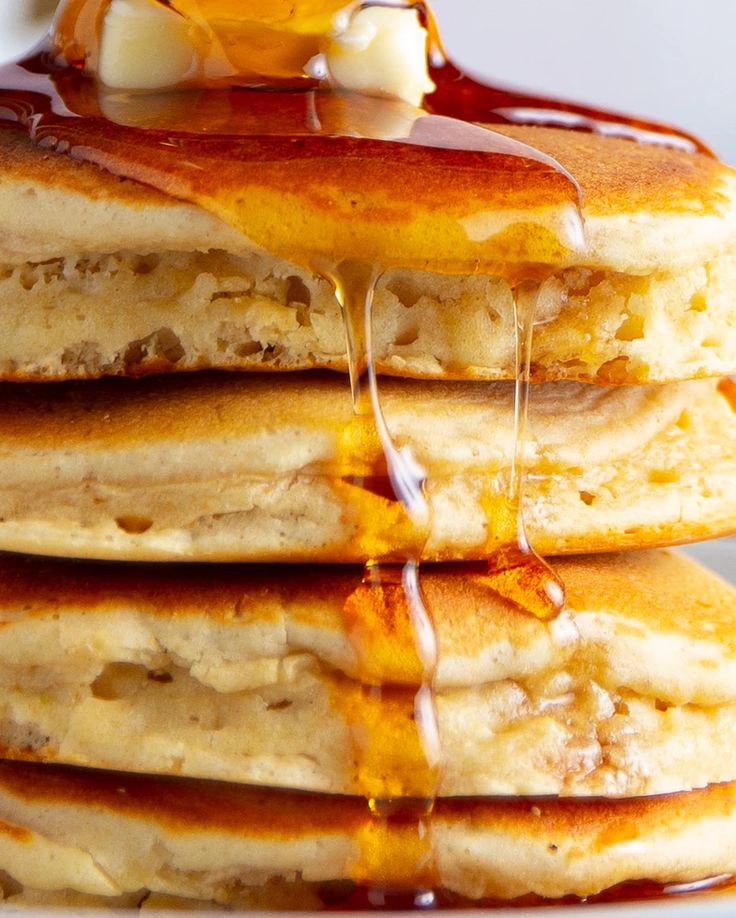 a stack of pancakes with syrup and butter on top