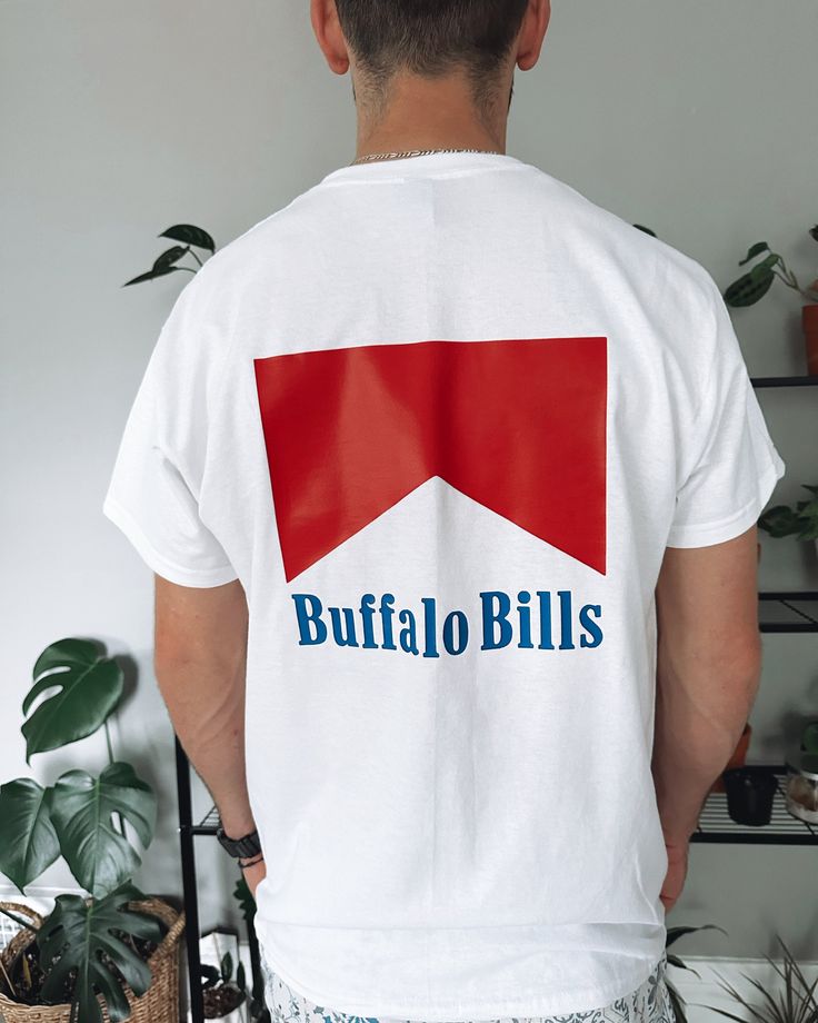 the back of a man wearing a white buffalo bills t - shirt with blue and red arrows on it