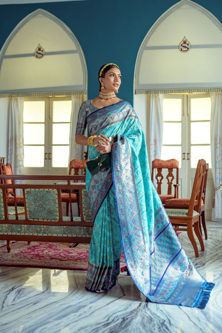 Saree Fabric : Banarasi Silk Saree Color : Teal Blue Saree Length : 5.5 Meter Blouse Length : 0.8 Meter Saree Work : Meenakari Woven Patola Saree Border : Zari Woven Border Wash : Dry Clean Designer Blue Banarasi Silk Sets, Designer Meenakari Blue Lehenga, Traditional Turquoise Wear With Zari Weaving, Designer Blue Paithani Silk Lehenga, Turquoise Banarasi Silk Traditional Wear, Blue Banarasi Silk Lehenga With Meenakari, Traditional Turquoise Saree With Zari Weaving, Designer Blue Saree For Transitional Season, Blue Designer Saree For Transitional Season