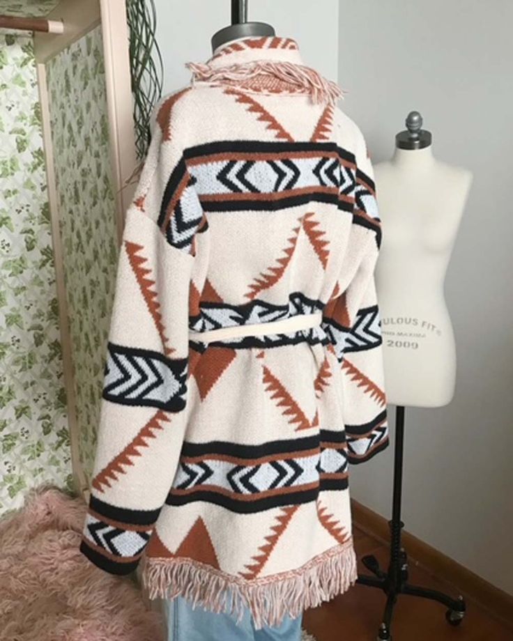 A stunning knit blanket sweater that is perfectly cozy for the season. Open front & soft fringe fold over collar. Color: Cream, camel & black Poly Hand wash cold Model is a size 8 wearing a medium. Small Medium Large Bust 50 52 53 Waist 49 51 52 Hips 51 53 54 Length 31 31 31 Bust, waist, and hip measurements are a total circumference. Length is measured from the top of the shirt to the hem. Measurements are an estimate. Winter Outerwear With Tassels And Long Sleeves, Winter Long Sleeve Outerwear With Tassels, Beige Shawl Collar Sweater Coat For Fall, Knit Outerwear With Fringe For Fall, Knit Fringe Outerwear For Fall, Cozy Shawl Collar Sweater For Fall, Long Sleeve Camel Sweater For Fall, Camel Long Sleeve Sweater For Fall, Fringe Long Sleeve Outerwear For Winter