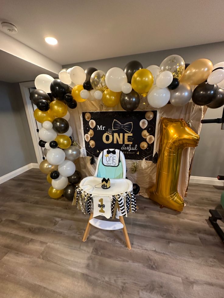 a baby's first birthday party with balloons and decorations